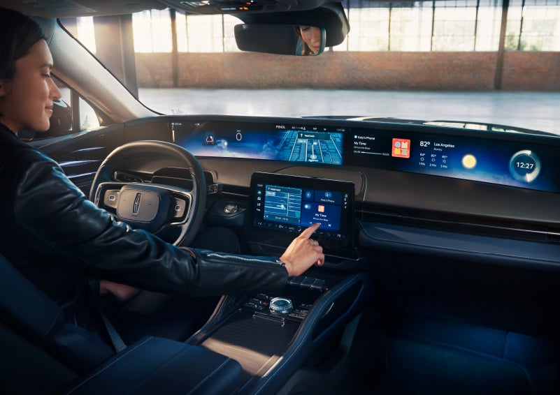 The driver of a 2024 Lincoln Nautilus® SUV interacts with the center touchscreen. | Duncan Lincoln in Blacksburg VA
